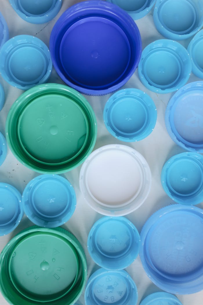 why-choose-us Aerial view of assorted colorful plastic bottle caps highlighting recycling and sustainability.