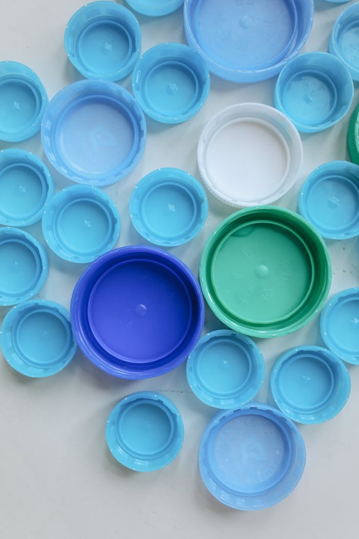 services-04 Top view of assorted colorful plastic bottle caps, promoting recycling and sustainability.