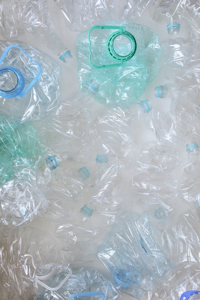 services-06 Top view of crumpled plastic bottles, symbolizing recycling and sustainability.