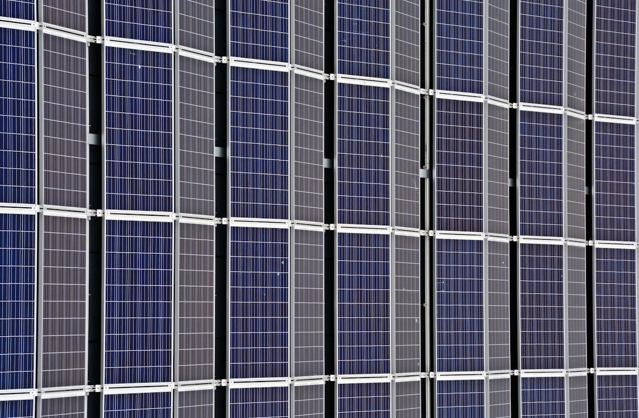 services-bg Close-up of multiple solar panels representing renewable energy and sustainability.